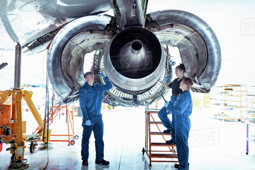 Aviation maintenance team inspecting a jet engine
